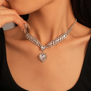 Close-up of heart-shaped crystal pendant necklace with multi-row zircon pavé settings