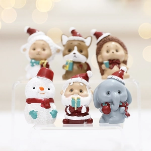 Miniature Christmas figurines including Santa and Snowman on an acrylic display stand