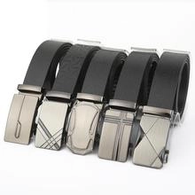 Close-up of assorted men's black leather belts with various metal automatic buckles