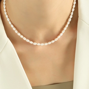 Elegant freshwater pearl necklace with uniform cream pearls on a white blazer model