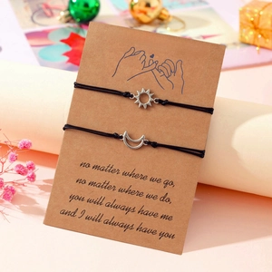 Detailed view of sun and moon couple bracelets on Pinky Promise card with warm gift box
