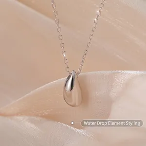 Polished S925 sterling silver water drop pendant necklace on elegant satin backdrop