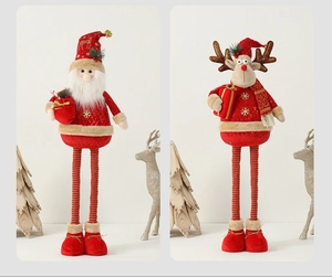 Detail of plush Christmas gnomes with long striped legs and snowflake embroidery