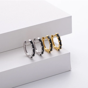 Detailed view of gold and silver S925 sterling silver hoops with black square zircons