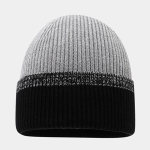 Close-up of a two-tone knit beanie featuring grey and black ribbed textures for winter