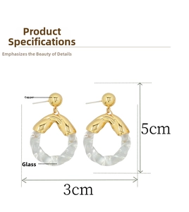 Detail view of round glass earrings in gold-tone copper, size 5cm x 3cm with material specs