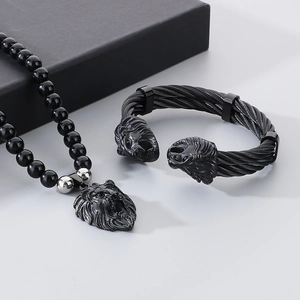 Detail of black onyx bead necklace and lion head braided steel cable bracelet set
