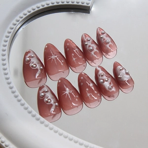 Almond shaped bean paste pink press-on nails with 3D pearls and silver metallic studs