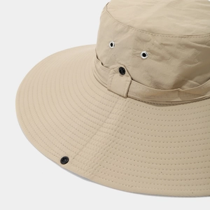 Detailed view of khaki hiking hat featuring reinforced stitching and metal air vents