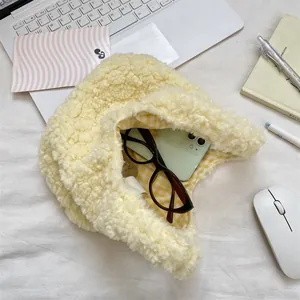 Detail showing plush yellow sherpa bag interior with plaid lining and phone storage