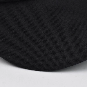 Close-up of the black knit fabric texture showing fine weave detail of the beret hat