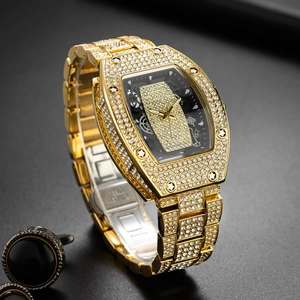 Macro shot of gold tonneau watch with full diamond setting and hollow skeleton dial