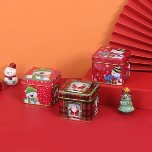 Square Christmas tin boxes for candies with Santa and snowman patterns in festive red colors