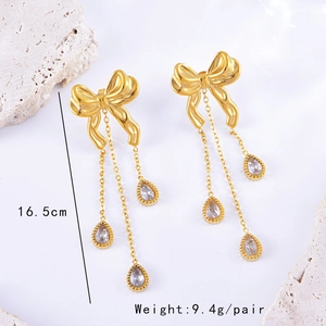 Detail view of golden bow earrings with long tassels and water drop crystals, length 16.5cm