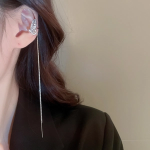 Detail of silver butterfly ear cuff with sparkling zircon fringe and pearl on ear