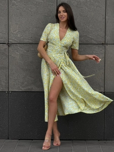 Detail of yellow floral wrap dress with V-neck, short sleeves and side slit design