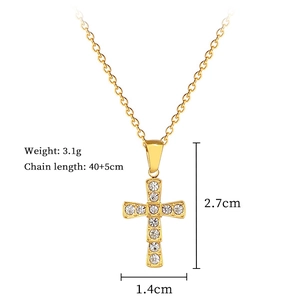 Detail view of gold cross pendant with clear gems, size 2.7x1.4cm and weight 3.1g