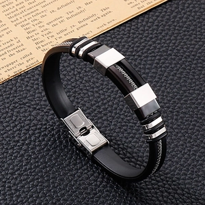Detail of stainless steel clasp and black silicone band on masculine fashion bracelet