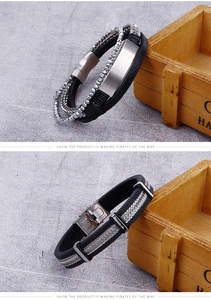 Detail of men's leather bracelets with stainless steel beads and engraved metal clasp