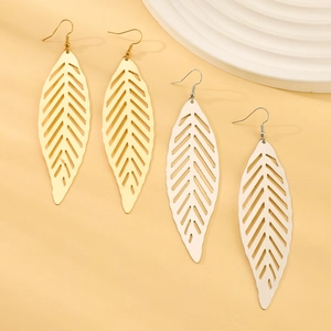 Detailed macro view of hollow leaf drop earrings in gold and white finish