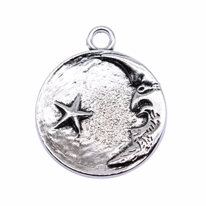Silver vintage celestial pendant featuring moon and stars relief on a round alloy charm