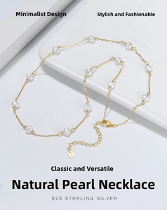 Detailed macro view of S925 sterling silver lobster clasp and natural pearls on gold chain