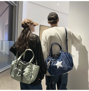 Detailed view of light green and dark blue waterproof tote bags with star pattern