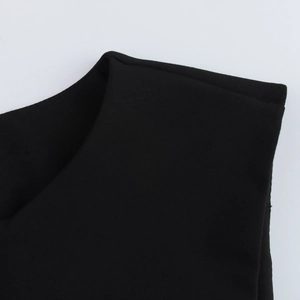 Detail view of the round neck shoulder cut and premium woven texture of the black vest top