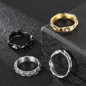 Irregular wave and hammered metal rings in gold, black, and silver stainless steel