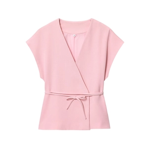 Detail showing pink sleeveless V-neck top with cross-tie design and fabric texture