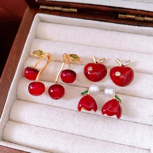 Red cherry and tulip earrings set in gold finish with pearls and crystals