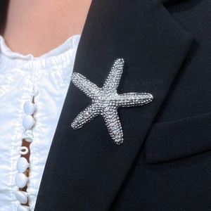 Elegant starfish brooch with sparkling crystals on a black suit lapel accessory