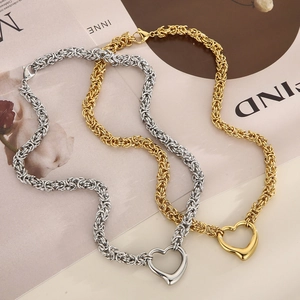 Close-up of gold and silver Byzantine chain necklaces with open heart pendants