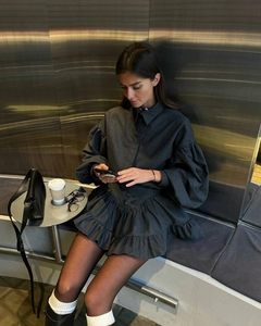Detail of grey plaid two-piece set with puff sleeves and ruffled skirt hem texture