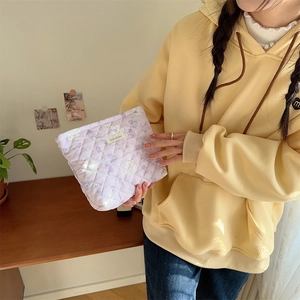 Quilted floral makeup bag detail showing lavender fabric and soft cotton texture