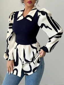 Detail of blue knit patchwork top with abstract black and white print puff sleeves