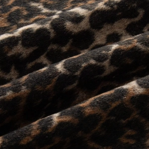 Detailed macro shot of premium leopard print wool fabric texture and soft material surface