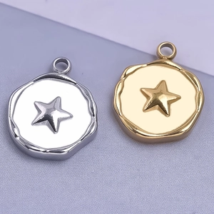 Macro shot of gold and silver irregular coin pendants with embossed star design for DIY jewelry