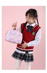 Close-up of pink insulated lunch bag with rainbow prints held by a schoolgirl