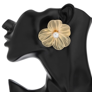 Detail of golden ginkgo leaf flower earrings with white pearl on black model