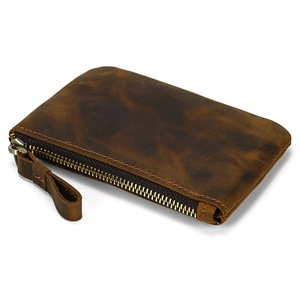 Detail view of deep brown crazy horse leather coin purse with vintage texture and zipper
