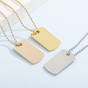 Three minimalist stainless steel dog tag necklaces in gold, silver, and rose gold finishes