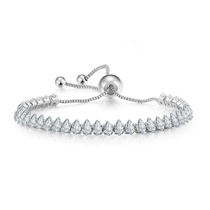 Detailed macro view of silver tennis bracelet featuring marquise-cut cubic zirconia crystals