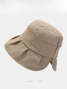 Detailed close-up of a beige bucket hat with textured horizontal ripples and folded brim