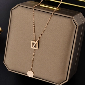 Rose gold Y-shaped titanium necklace with square pendant and Good Luck round charm