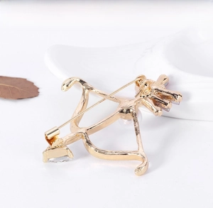 Detailed back view of a gold-plated pearl brooch showing the secure pin fastener
