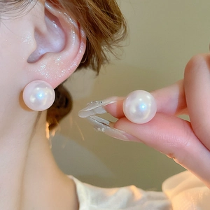 Elegant large round faux pearl stud earrings with a delicate pink iridescent luster