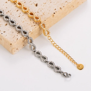 Detailed view of infinity charm bracelets in gold and silver with cubic zirconia inlay