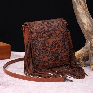 Retro bohemian leather crossbody bag with floral embossing and long side fringes