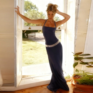 Detailed close-up of the silver sequin waistband on this navy blue halter evening dress